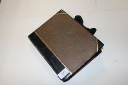 A scrap album and contents of various postcards et