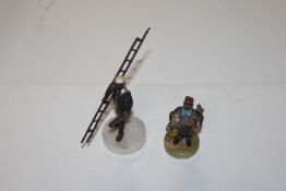 Two Bergman style figures, one of a workman and th