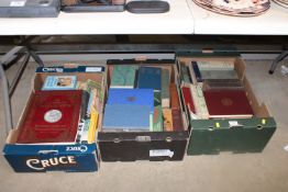 Three boxes containing various books