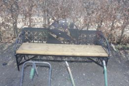A metal and wooden garden bench decorated with a d
