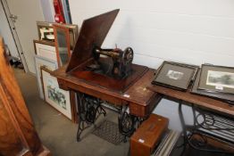 An oak Singer sewing table fitted with Singer sewi
