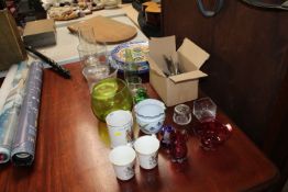 A collection of various glassware to include cranberry glass examples; paperweights; a Studio