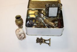 A tin containing a miniature brass vase; picture f