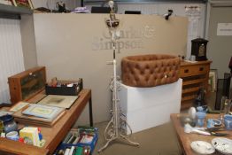 A wrought iron adjustable standard lamp