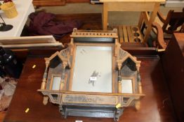 A wooden and gilt decorated wall hanging mirror