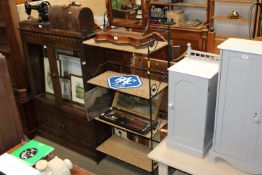 A wicker and wrought iron shelving unit