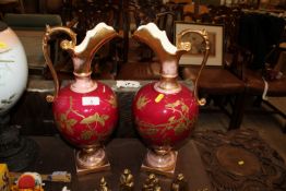 A pair of Rubian Art Pottery gilt decorated ewers
