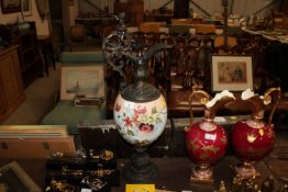A metal and opaque glass ewer with cherub and flor
