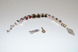 A box containing cuff links, brooches, and studs