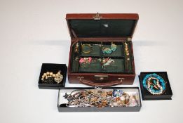 A box containing three boxes of various jewellery