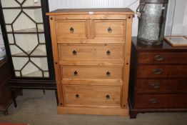 A modern pine chest fitted two short over three lo