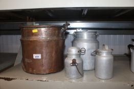A copper swing handled pot and three small milk churns
