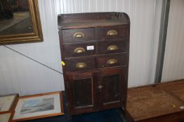 A table top chest fitted six drawers raised on cup
