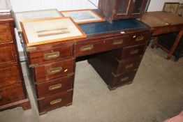 A mahogany twin pedestal campaign style desk fitte