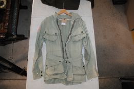 A US WWII patt. M42 Paratroopers jump jacket, the right arm having US Flag insignia with 48 Stars (