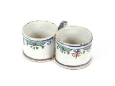 An 18th Century Delftware double cup, with floral decoration and loop handle, 18cm