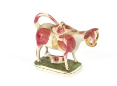 A 19th Century Staffordshire cow creamer group, with cow and calf, having pink patch decoration,