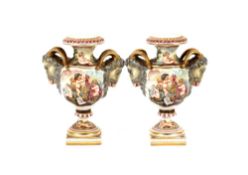 A pair of 19th Century Continental porcelain baluster vases, decorated cherubs and rams head