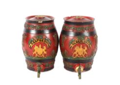 A pair of 19th Century red glazed pottery barrels, with vine and floral decoration and brass taps,