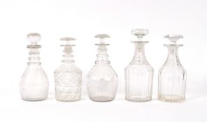 A near pair of 19th Century ring neck decanters, the largest 27cm high; a near pair of triple ring