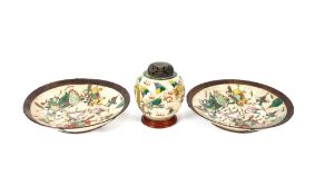 A pair of Chinese crackle glazed chargers, enamel decorated with warriors within a bronze effect