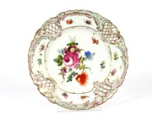 A pair of 19th Century German porcelain cabinet plates, having foliate decoration within gilt