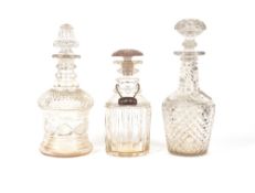 A cut glass decanter of thistle shape, with hobnail decoration, 29cm high; another similar 32cm high