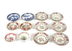 Nine 19th Century famille rose shallow dishes, of octagonal form; a pair of saucer dishes, decorated