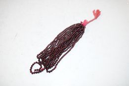 A collection of garnet beads for threading