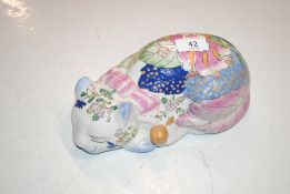 A Canton style pottery recumbent cat ornament