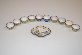 An Oriental enamel decorated dish and ten cups