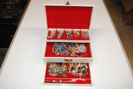 A cantilever jewellery box containing costume jewe