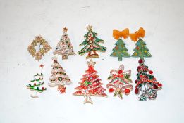 A tray of Christmas themed brooches