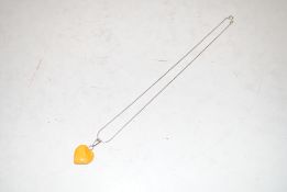 A vintage sterling silver and egg yolk amber neckl