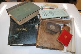 Two albums of postcards; an album of cigarette car