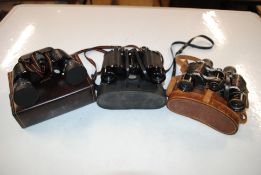 A leather cased pair of Magon 8x30 binoculars; a pair of Viking 8x42 binoculars and one other pair