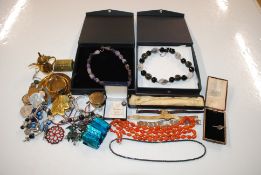 A plastic box containing various costume jewellery