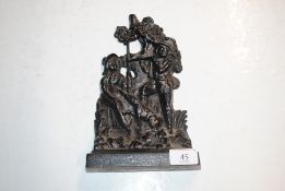 A cast iron figural decorated doorstop