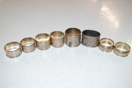 Six various silver napkin rings, 125gms and two wh