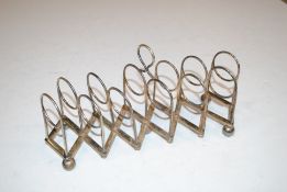 A silver plated extending toast rack engraved 'Sel