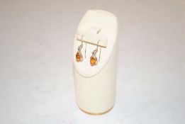 A pair of vintage sterling silver and amber drop e