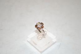 A sterling silver, golden and white topaz ring, si