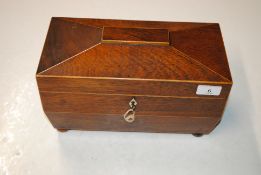 A 19th Century interior mahogany and boxwood strung sarcophagus shaped tea caddy with cannisters and