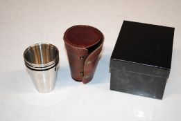 A boxed set of four metal drinking cups for gun po