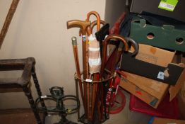 A brass and iron stick stand together with a quant