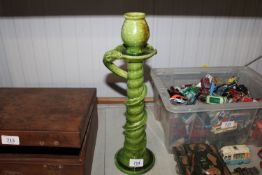 A Studio pottery candlestick having snake decorati