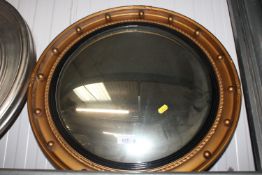 A gilt framed convex wall mirror
