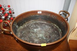 A copper twin handled preserve pan