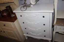 A modern white ornate decorated chest fitted four
