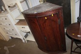 An oak inlaid corner cabinet